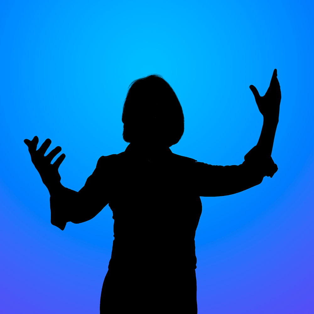 Silhouetted person with arms raised against a blue gradient background, conveying celebration or emphasis.